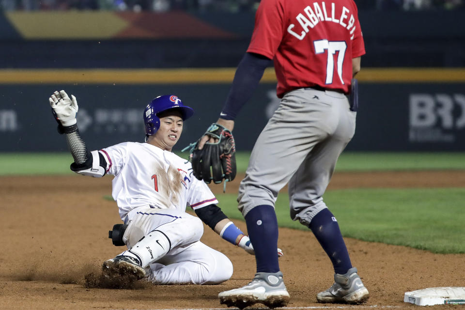 Taiwan's batter Tsung-Che Cheng slides into third base during the Pool A game of the World Baseball Classic (WBC) gainst Panama held at the Taichung Intercontinental Baseball Stadium in Taichung, Taiwan, Wednesday, March 8, 2023, (AP Photo/I-Hwa Cheng)