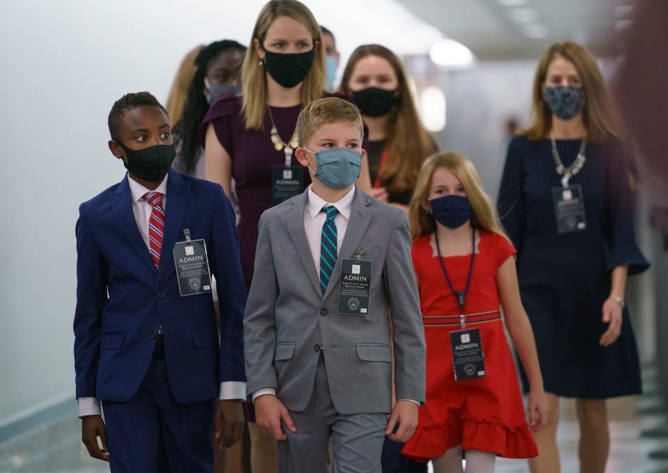 The children of then-Supreme Court nominee Amy Coney Barrett wait for their mother to enter the hearing room.