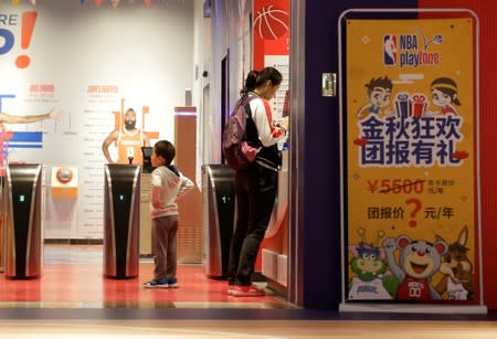 A boy waits to enter the NBA Playzone at a shopping mall in Beijing