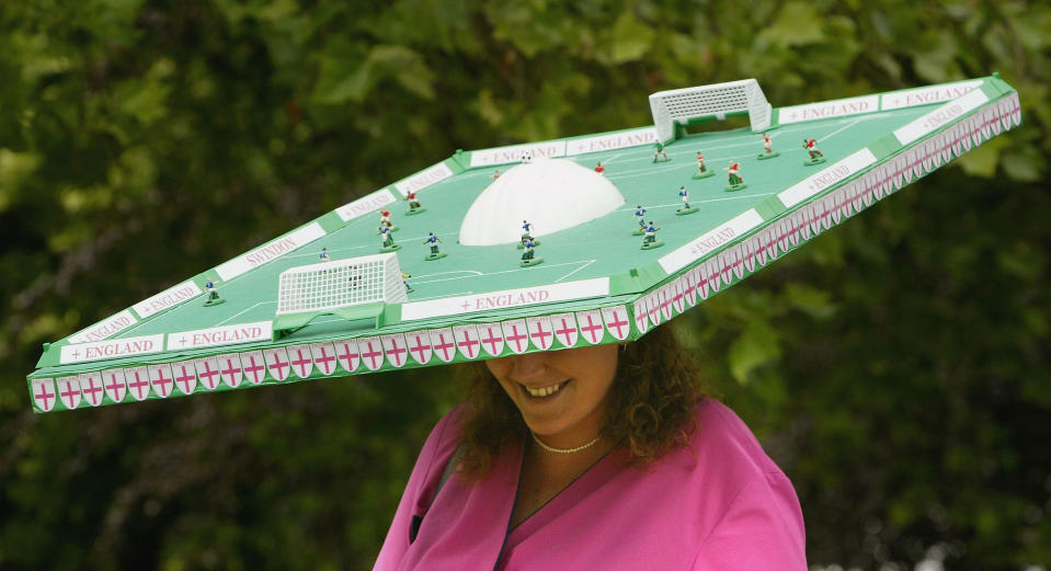 A lady wears a mini football pitch on her head at the 2004 Royal Ascot.