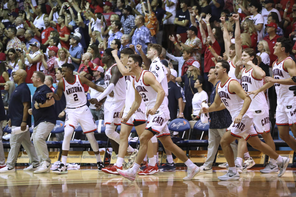 Arizona players run onto the court after the team's win over Creighton in an NCAA college basketball game Wednesday, Nov. 23, 2022, in Lahaina, Hawaii. (AP Photo/Marco Garcia)