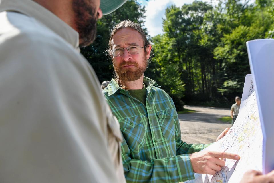 Josh Kelly, public lands biologist with the Asheville-based environmental nonprofit MountainTrue, discusses an area of the Twelve Mile Project while looking at a map with Jason Herron, environmental coordinator with the U.S. Forest Service’s Pisgah Zone, July 24, 2019.