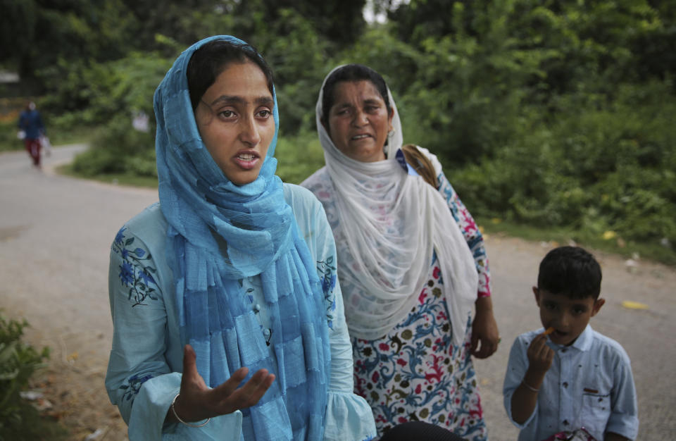 Maryam Rasool, wife of a Kashmiri prisoner Aamir Parviaz Rather who is lodged in Agra Central Jail, speaks with the Associated Press after meeting her husband, as her mother-in-law cries in Agra, India, Friday, Sept. 20, 2019. Rather was picked up by the armed forces on the morning of Aug. 6 and held in various jails in Kashmir before being moved to Agra. The family was seeing him for the first time in 48 days. “We hugged each other and cried. His face was swollen because of the heat. If they keep him for long, he won’t survive,” Maryam said, tugging her 5-year-old son closely to her. (AP Photo/Altaf Qadri)