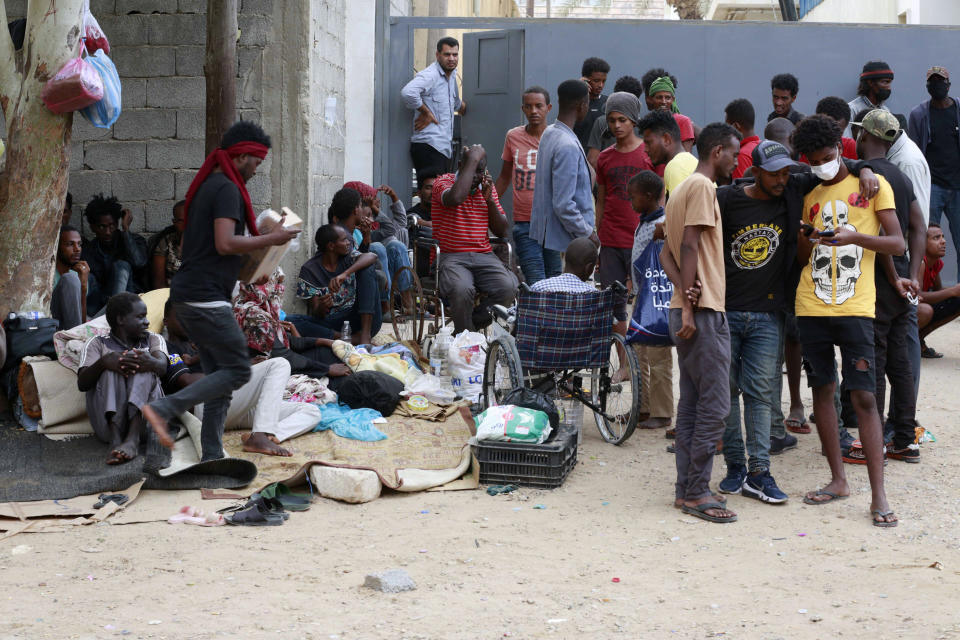 Migrants protest, Saturday, Oct. 9, 2021, in front of the office of the United Nation’s humanitarian body in Tripoli, Libya. The demonstration comes after U.N. officials said on the same day that guards at a Libyan detention center for migrants shot and killed at least six people amid chaos in the overcrowded facility. (AP Photo/Yousef Murad)