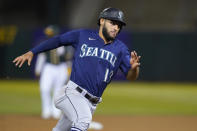 Seattle Mariners' Abraham Toro runs home to score against the Oakland Athletics during the fourth inning of a baseball game in Oakland, Calif., Wednesday, Sept. 22, 2021. (AP Photo/Jeff Chiu)