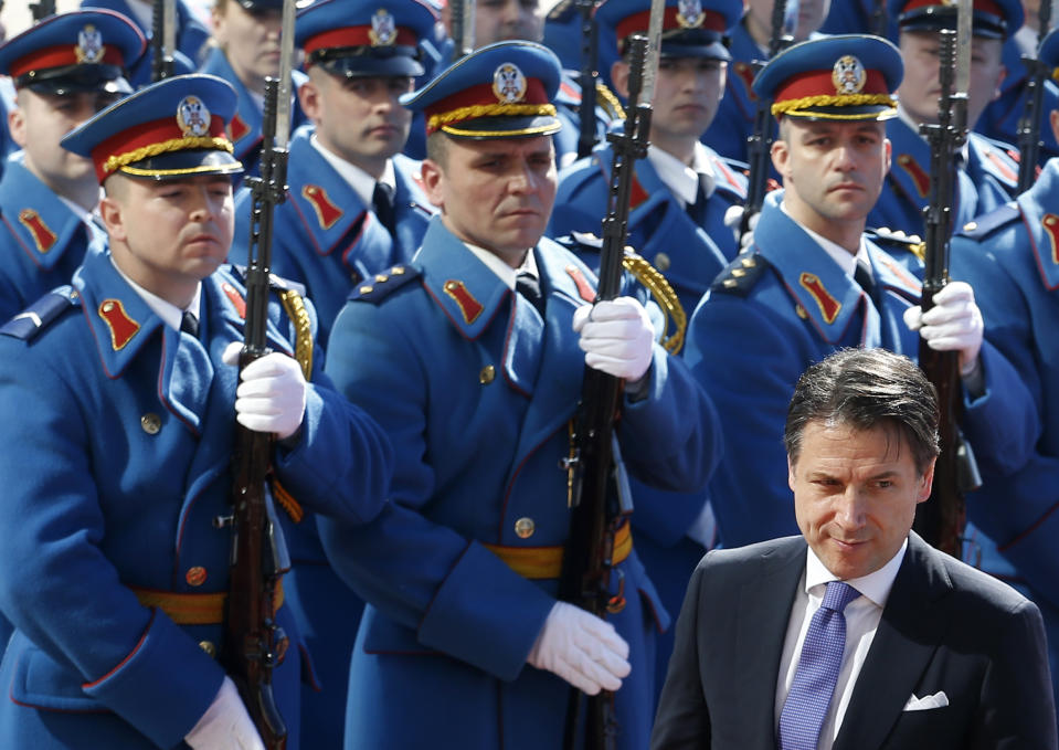 Italian Prime Minister Giuseppe Conte reviews the honor guard during a welcome ceremony ahead of meeting with his Serbian counterpart Ana Brnabic at the Serbia Palace in Belgrade, Serbia, Wednesday, March 6, 2019. Conte is on a one-day official visit to Serbia. (AP Photo/Darko Vojinovic)