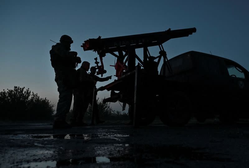 Members of company tactical group "Steppe Wolves" prepare a handmade small MLRS for firing toward Russian troops in Zaporizhzhia region