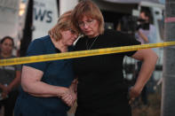 <p>Joan Stanley (L) and her daughter Kellie Hawkins embrace at a barricade near the First Baptist Church of Sutherland Springs on November 6, 2017 in Sutherland Springs, Texas. (Photo: Scott Olson/Getty Images) </p>