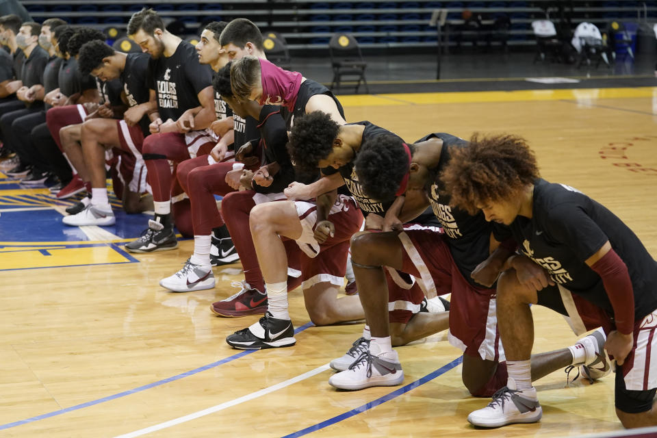 Washington State players kneel during the national anthem before an NCAA college basketball game against Stanford in Santa Cruz, Calif., Saturday, Jan. 9, 2021. (AP Photo/Jeff Chiu)