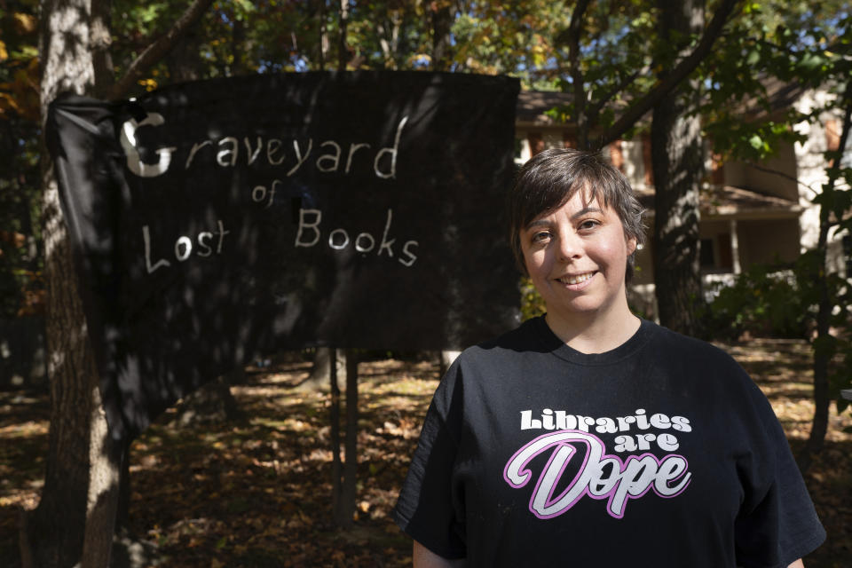 Bernadette Chimner poses for a portrait in front of Halloween decoration highlighting books removed from Spotsylvania schools, at her home in Fredericksburg, Va., Oct. 26, 2023. (AP Photo/Serkan Gurbuz)