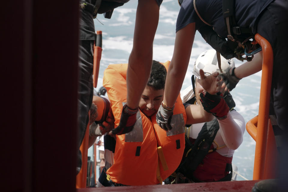 A man is helped onto the Ocean Viking after being rescued from a small and overcrowded wooden boat some 53 nautical miles (98 kilometers) from the coast of Libya in the Mediterranean Sea, Tuesday, Sept. 17, 2019. The humanitarian rescue ship pulled 48 people from the boat including a newborn and a pregnant woman. (AP Photo/Renata Brito)