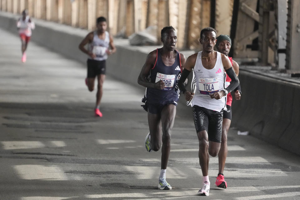 Tamirat Tola, of Ethiopia, leads the men runners over the Queensboro Bridge during the New York City Marathon in New York, Sunday, Nov. 5, 2023. (AP Photo/Seth Wenig)