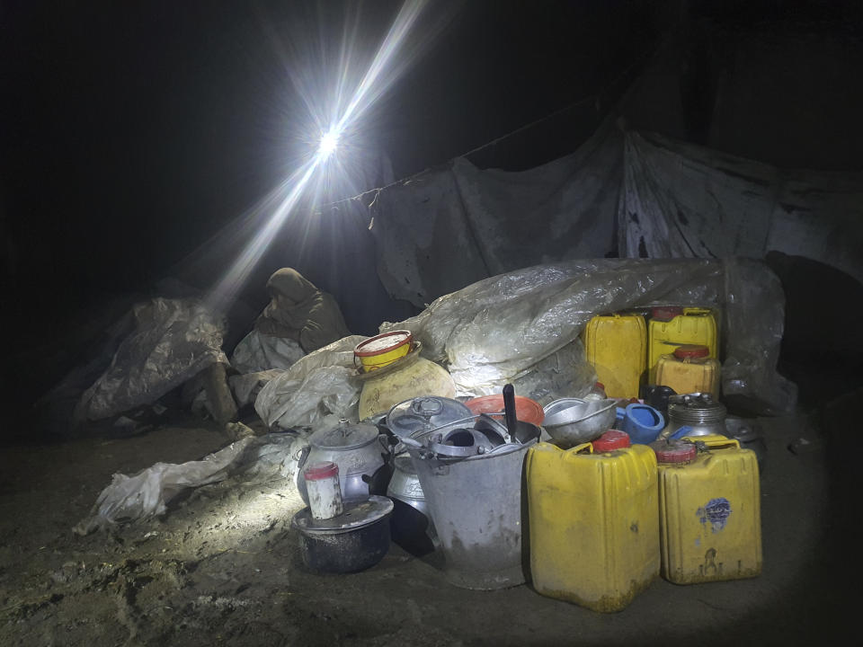 A woman sits inky a makeshift shelter in the village of Ryan, in Paktika province, Afghanistan, Wednesday, June 22, 2022. A powerful earthquake struck a rugged, mountainous region of eastern Afghanistan early Wednesday, flattening stone and mud-brick homes in the country's deadliest quake in two decades, the state-run news agency reported. (AP Photo/Ebrahim Nooroozi)