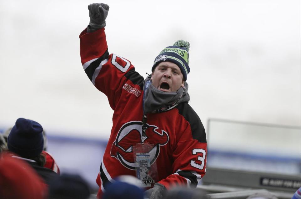 A New Jersey Devils fans cheers during the first period of an outdoor NHL hockey game against the New York Rangers Sunday, Jan. 26, 2014, at Yankee Stadium in New York. (AP Photo/Frank Franklin II)