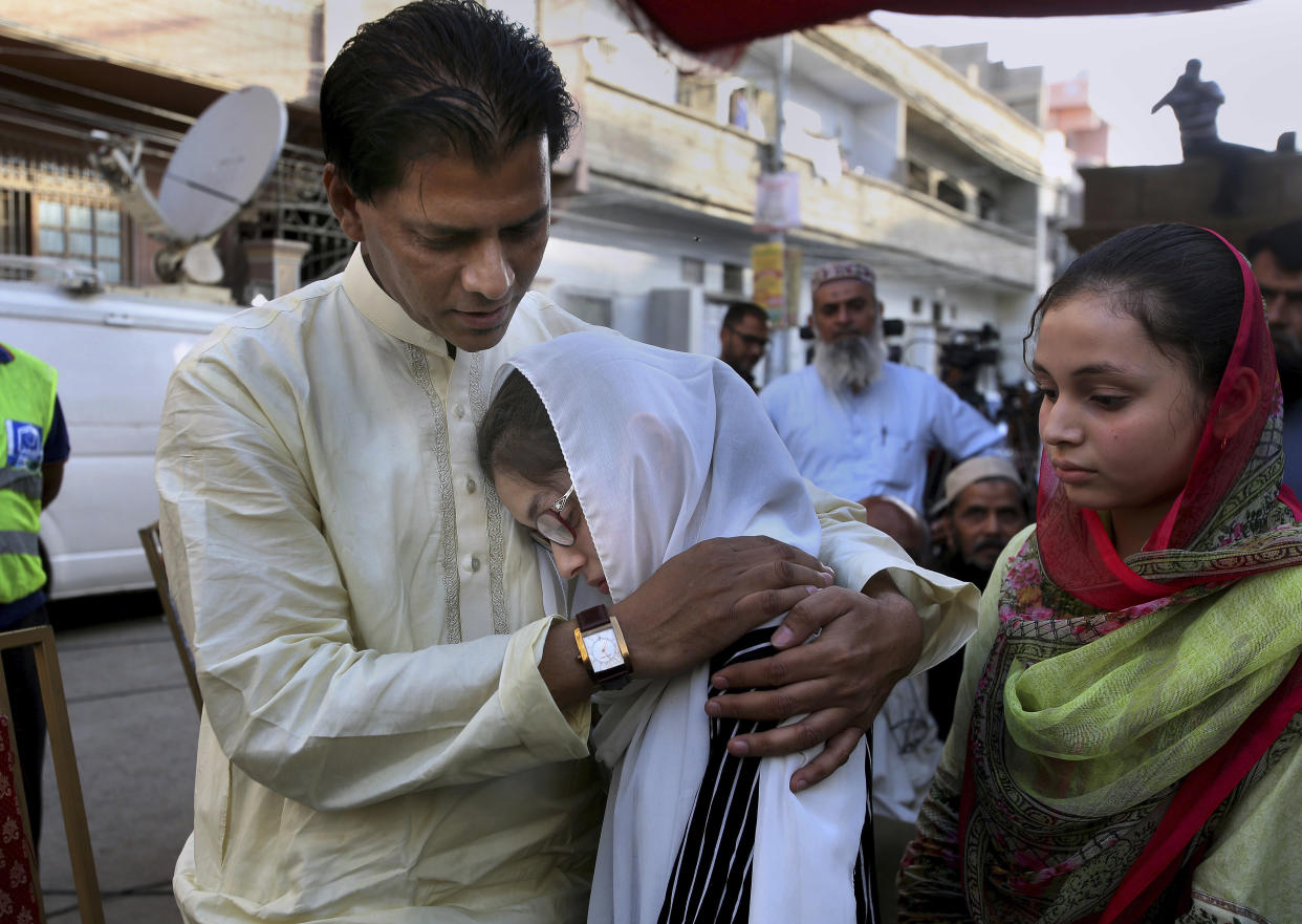 Abdul Aziz, father of Sabika Sheikh, the Pakistani exchange student killed in a mass shooting at a high school in Texas, consoles other family members. (Photo: Fareed Khan/AP)