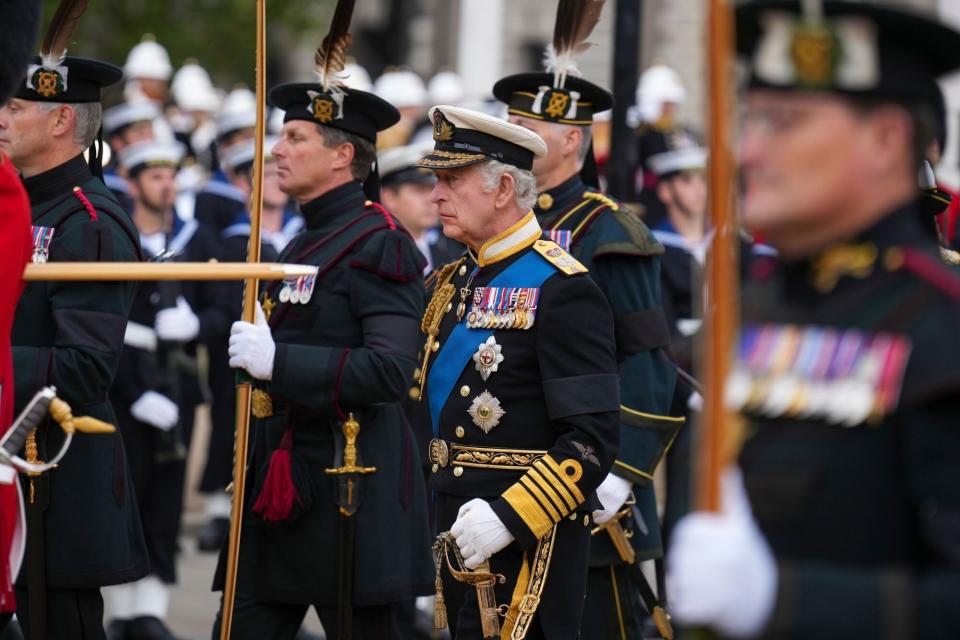 Mandatory Credit: Photo by Emilio Morenatti/AP/Shutterstock (13401778l) King Charles III follows a gun carriage carrying the coffin of Queen Elizabeth II during her funeral service in Westminster Abbey in central London .The Queen, who died aged 96 on Sept. 8, will be buried at Windsor alongside her late husband, Prince Philip, who died last year Royals Funeral, London, United Kingdom - 19 Sep 2022