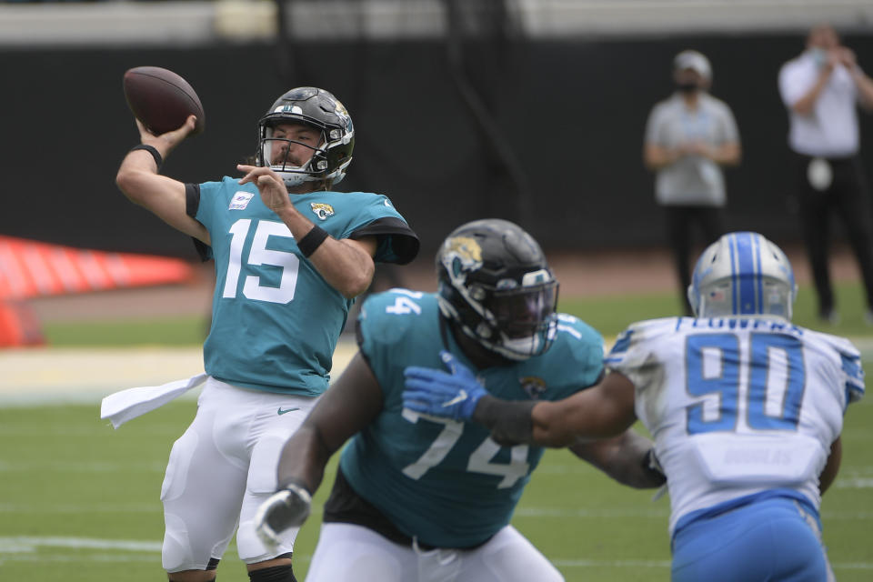 Jacksonville Jaguars quarterback Gardner Minshew II (15) throws a pass as offensive tackle Cam Robinson (74) blocks Detroit Lions defensive end Trey Flowers (90) during the first half of an NFL football game, Sunday, Oct. 18, 2020, in Jacksonville, Fla. (AP Photo/Phelan M. Ebenhack)