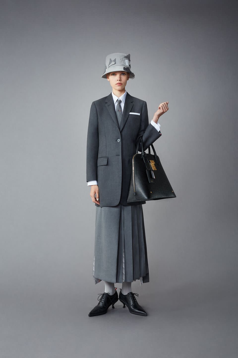 <p>Thom Browne is taking to the skies for resort—leveraging skyscapes of kites, hot-air balloons, and hector-shaped clouds on its fetching skirt suits and tailored separates. It's prep forever from Brown, with anoraks, blazers, pleated skirts, lace-ups and loafers done in a reserved palette of mostly gray, black, and white. But that doesn't mean that playful sensibility is lacking. </p>