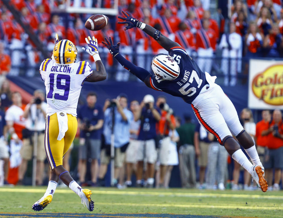 LSU wide receiver Derrick Dillon (19) catches a pass over the outstretched arms of Auburn linebacker Deshaun Davis (57) and runs in for a touchdown during the second half of an NCAA college football game, Saturday, Sept. 15, 2018, in Auburn, Ala. (AP Photo/Butch Dill)