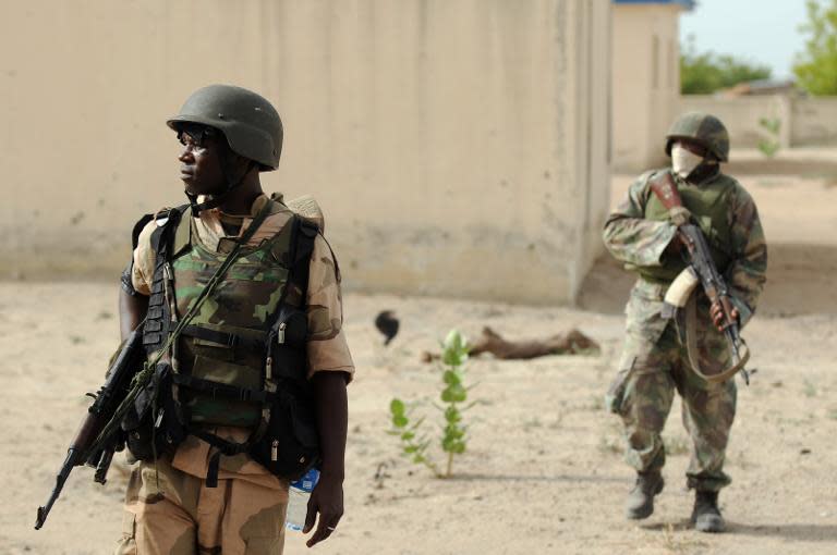 Nigerian soldiers patrolling in the north of Borno state close to a Islamist extremist group Boko Haram former camp near Maiduguri, northeast Nigeria on June 5, 2013