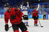 United States' Kenny Agostino, center, celebrates next to Canada's Maxim Noreau (56) after Agostino scored a goal during a preliminary round men's hockey game at the 2022 Winter Olympics, Saturday, Feb. 12, 2022, in Beijing. At left is Canada's Eric Staal (12). (AP Photo/Matt Slocum)