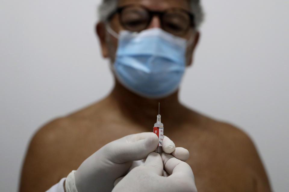 FILE - In this Jan. 15, 2021 file photo, a healthcare worker prepares a dose of China's Sinovac Biotech experimental vaccine for the new coronavirus to inject into a volunteer during the testing stage at the University Hospital of Brasilia, Brazil. The government has yet to approve a single vaccine, and Health Ministry officials have ignored outside experts’ advice. (AP Photo/Eraldo Peres, File)