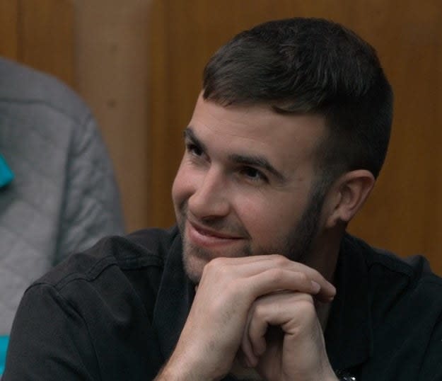 Ronald smiles in the "Jury Duty" courtroom