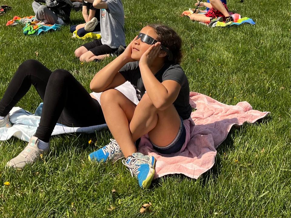 Third graders at Mulberry Elementary in Milford view the eclipse in their school yard.