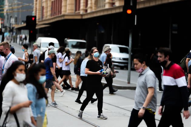 Locals near Melbourne's Flinders Street station on Thursday after Victoria reintroduced COVID-19 restrictions following a quarantine hotel worker testing positive on Wednesday.