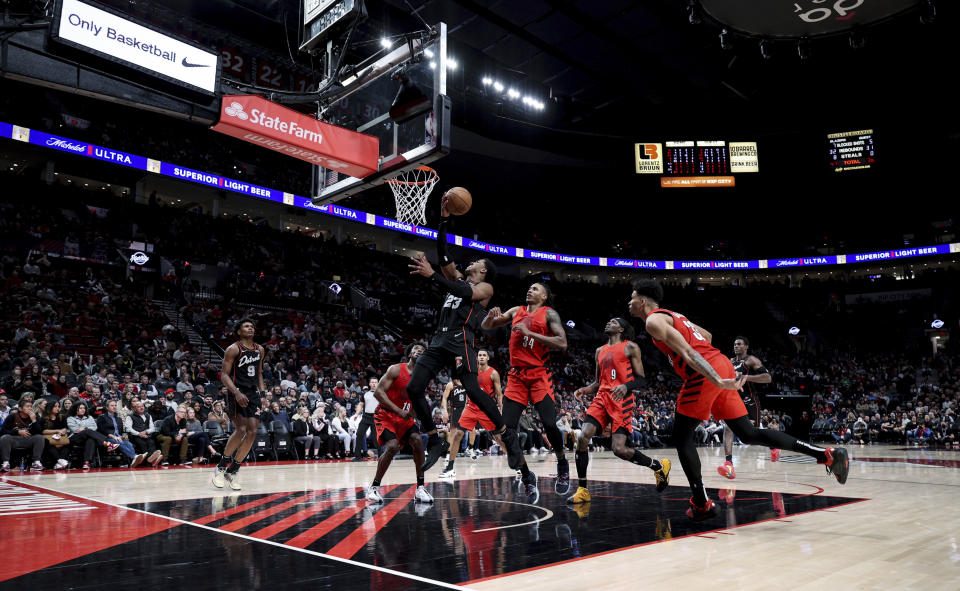 Detroit Pistons guard Jaden Ivey, middle, drives to the basket against the Portland Trail Blazers during the second half of an NBA basketball game Thursday, Feb. 8, 2024, in Portland, Ore. (AP Photo/Howard Lao)