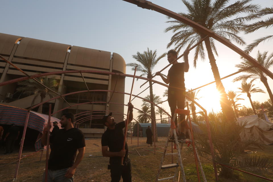 Followers of Shiite cleric Muqtada al-Sadr set up tents during outside the Iraqi Parliament,, during a sit-in protest, in Baghdad, Iraq, Wednesday, Aug. 3, 2022. The Influential Shiite cleric has told his followers to continue their sit-in inside Iraq's government zone, and called for the dissolution of the parliament and early elections. (AP Photo/Anmar Khalil)