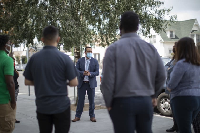 LOS ANGELES, CA - APRIL 14: Alejandro Martinez, chief real estate officer with the Coalition for Responsible Community Development, speaks with team members who will be helping with a relief program for small, South L.A. landlords in an effort to help them keep their properties. Photographed on Wednesday, April 14, 2021 in Los Angeles, CA. (Myung J. Chun / Los Angeles Times)