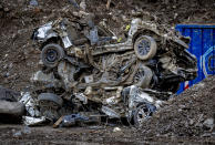 Damaged cars are piled up near the Ahr river in Resch in the Ahrtal valley, southern Germany, Tuesday, Dec.14, 2021. The region was hit by floodings exactly five months ago, causing the death of about 180 people. The floods in July claimed almost 200 lives, many of them in the narrow Ahr Valley that's best known for its vineyards and as a picturesque hiking destination. (Photo/Michael Probst)