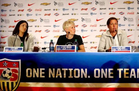 USA forward Abby Wambach (R) addresses the media as goalkeeper Hope Solo (L) and midfielder Megan Rapinoe look on at the USA women's national soccer team media day in New York, May 27, 2015. Mandatory Credit: Andy Marlin-USA TODAY Sports