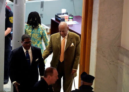 Actor and comedian Bill Cosby walks with his publicist Andrew Wyatt, during his sexual assault retrial at the Montgomery County Courthouse in Norristown, Pennsylvania, U.S. April 23, 2018. REUTERS/Jessica Kourkounis