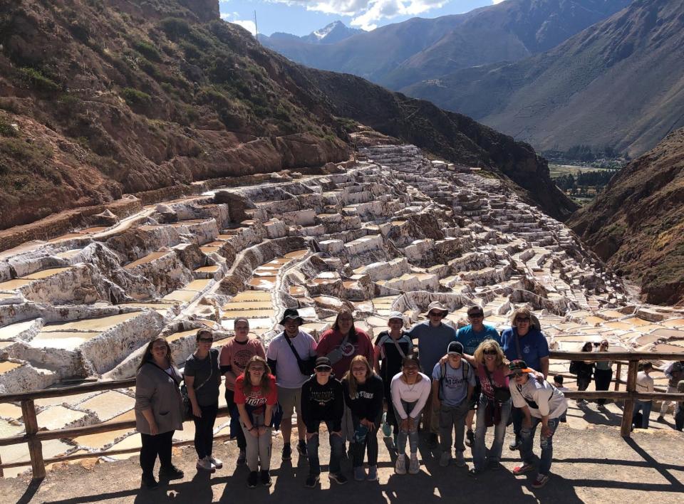 Participants in the Mapleton High School trip to Peru pose at Maras Salt ponds