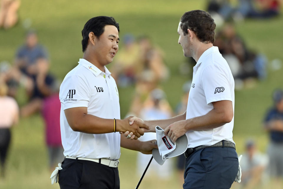 Tom Kim, of South Korea, left, shakes hands with Patrick Cantlay after Kim won the Shriners Children's Open golf tournament, Sunday, Oct. 9, 2022, in Las Vegas. (AP Photo/David Becker)