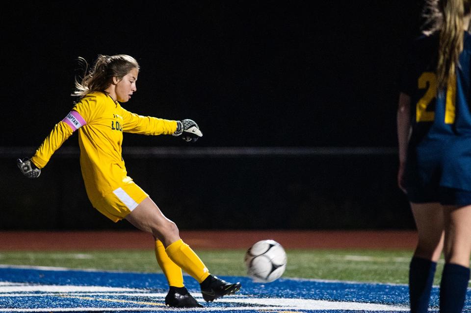 Lourdes goalie Cassie Gallagher clears the ball after a save during the MHAL soccer championship game at Wallkill High School on Thursday, October 20, 2022.