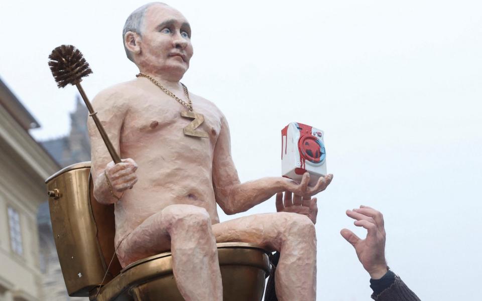 A sculpture of Russian President Vladimir Putin is displayed by demonstrators outside Prague Castle - EVA KORINKOVA/REUTERS