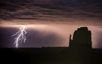 <p>Rain and lightning bolts hammer the desolate terrain of Monument Valley, Ariz. (Photo: Jennifer Khordi/Caters News) </p>