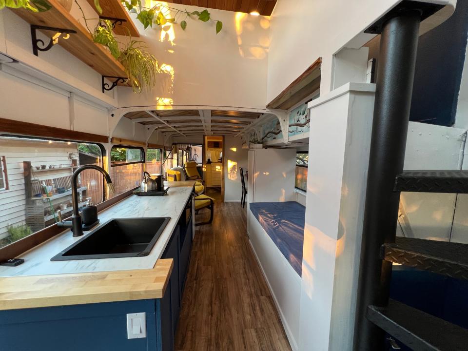 The kitchen and reading nook on the first floor of the converted bus.