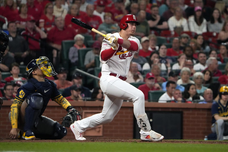 St. Louis Cardinals' Nolan Gorman, right, follows through on a two-run double as Milwaukee Brewers catcher William Contreras watches during the sixth inning of a baseball game Monday, May 15, 2023, in St. Louis. (AP Photo/Jeff Roberson)