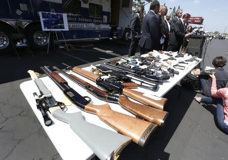 Seized weapons are displayed at a news conference announcing federal racketeering charges against suspected members of the Broadway Gangster Crips street gang in Los Angeles, California June 17, 2014. REUTERS/Jonathan Alcorn