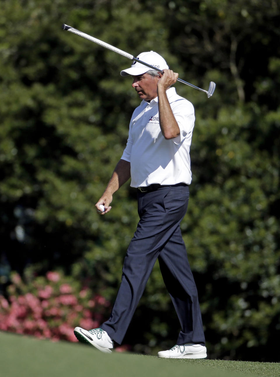 Fred Couples holds up his putter after a birdie on the nine hole during the third round of the Masters golf tournament Saturday, April 12, 2014, in Augusta, Ga. (AP Photo/Darron Cummings)