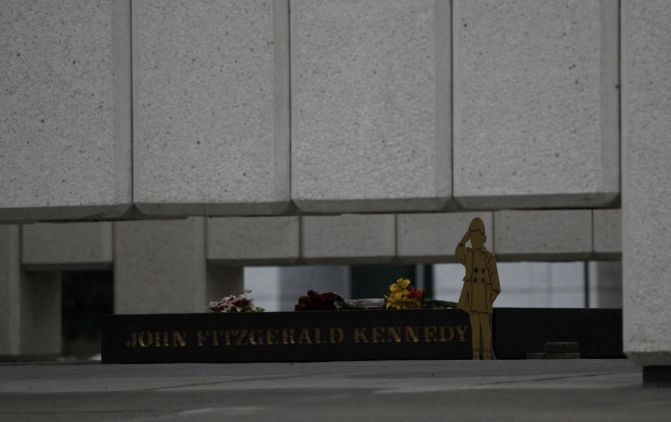 A silhouette of JFK Jr. saluting his father's casket at President Kennedy's state funeral is seen at John F. Kennedy Memorial Plaza in Dallas