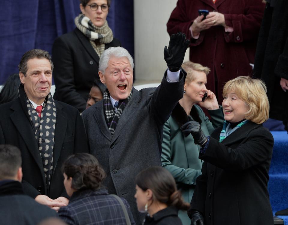 Former US President Bill Clinton (C), his wife Hillary Rodham Clinton (R) and New York Governor Andrew Cupomo (L) arrive for the  inauguration of New York City Mayor Bill de Blasio on the steps of City Hall in Lower Manhattan on January 1, 2014 in New York. Democrat De Blasio is sworn in as mayor of New York in a ceremony on the steps of city hall overseen by former US President Bill Clinton. (Photo credit should read STAN HONDA/AFP/Getty Images)