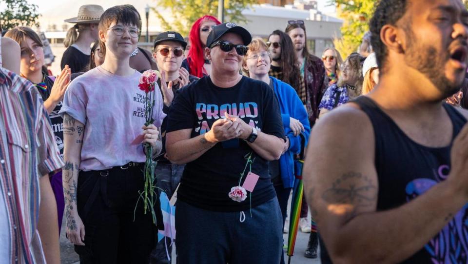 People carry signs and flags in support of transgender people during the Trans March in Boise, Friday, September 13, 2024.