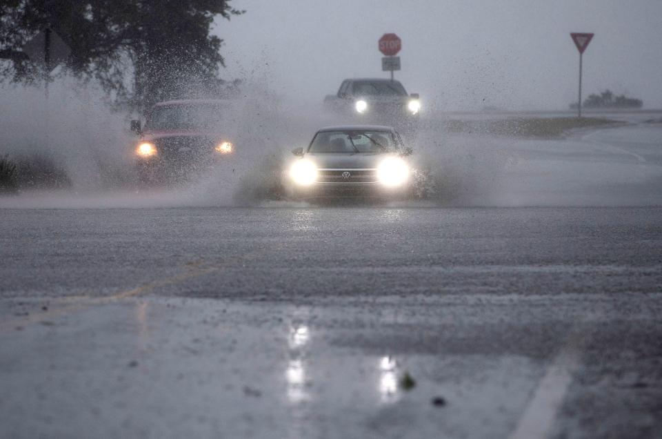 Motorists take chances traveling through flooded roadways in downtown Pensacola on Wednesday, April 10, 2024.