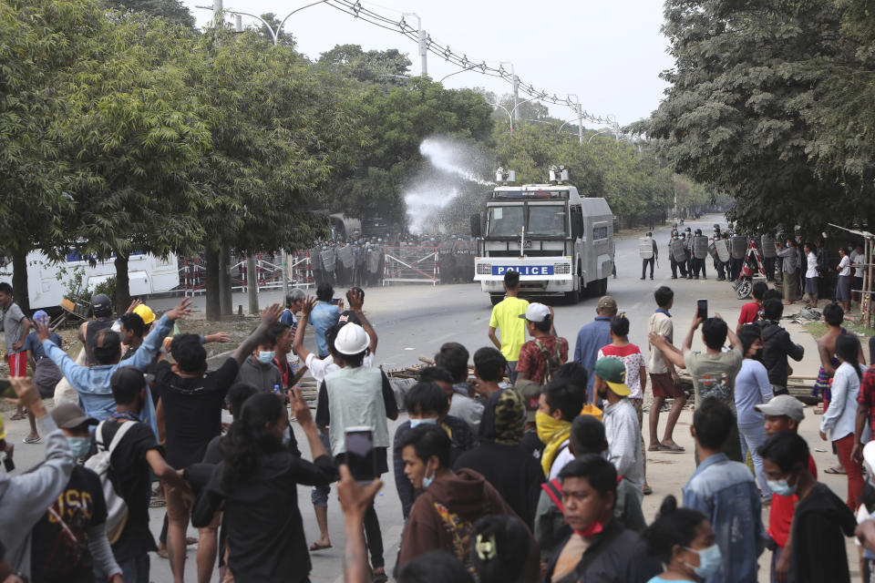 A police truck uses a water cannon to disperse protesters in Mandalay, Myanmar, on Saturday, Feb. 20, 2021. Security forces in Myanmar ratcheted up their pressure against anti-coup protesters Saturday, using water cannons, tear gas, slingshots and rubber bullets against demonstrators and striking dock workers in Mandalay, the nation's second-largest city. (AP Photos)