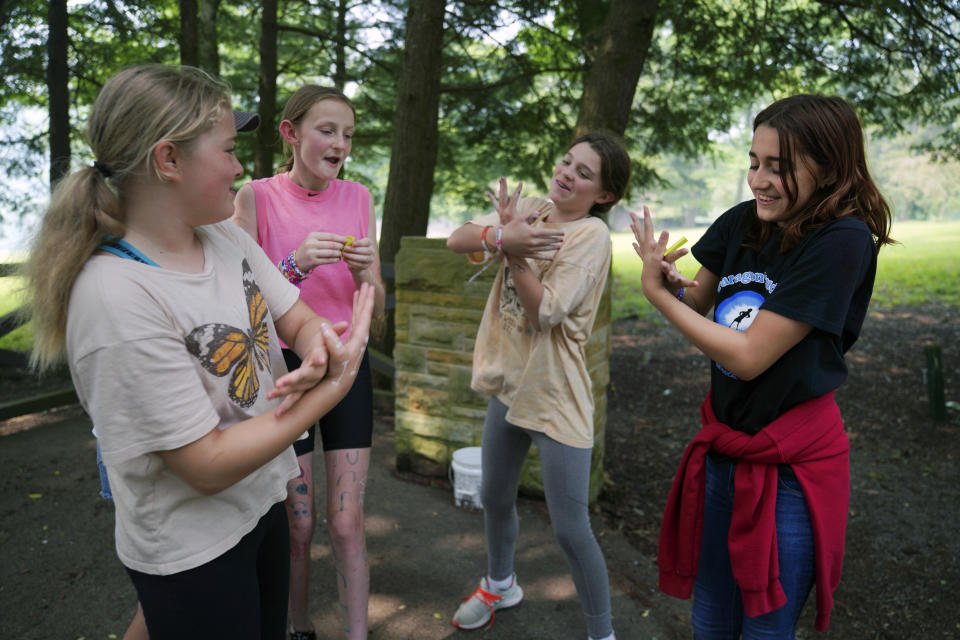 Campers sing together while playing a game of charades at the YMCA Camp Kon-O-Kwee Spencer on Thursday, June 29, 2023, in Zelienople, Pa. Due to the poor air quality caused by the Canadian wildfires the Western Pennsylvania summer camp closed its outdoor pool and sent home a few campers with health problems. (AP Photo/Jessie Wardarski)